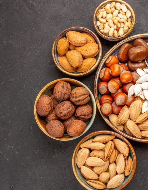top-view-walnuts-peanuts-other-nuts-dark-surface